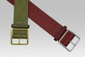 Two overlapping belts, one olive green with a metal buckle and one burgundy with a loop buckle, displayed on a gray background as part of a mockup template. - PSD Mockup