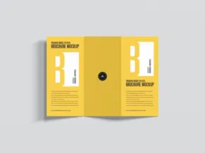 Open brochure mockup with yellow covers and white text, displayed on a light gray background. - PSD Mockup