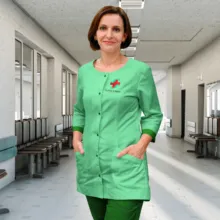 A healthcare worker in green scrubs standing in a hospital corridor. - PSD Mockup