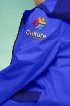 Blue jacket mockup with a 'culture' logo embroidery. - PSD Mockup