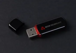 USB flash drive with a black and red design, labeled "data encryption," on a dark gray background, serving as a template. - PSD Mockup