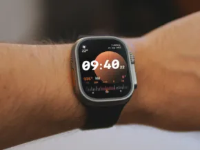 A person wearing a smartwatch that shows a mockup display of the time and fitness metrics. - PSD Mockup