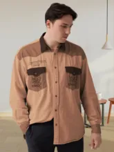 A man in a beige shirt with dark brown pockets standing in a room with wooden furniture, perfect as a mockup template. - PSD Mockup