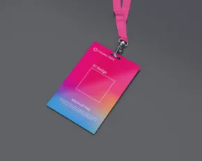 A colorful conference badge mockup with a pink lanyard on a grey surface. - PSD Mockup
