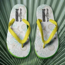 A white and yellow flip flop pair on a palm leaf mockup. - PSD Mockup
