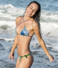 A woman in a bikini standing on the beach, mockup or template. - PSD Mockup