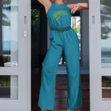 A woman in a teal jumpsuit posing in front of a door, serving as a mockup. - PSD Mockup