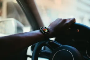 A template mockup of an apple watch on the steering wheel of a car. - PSD Mockup