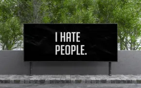 A black billboard mockup that says "I hate people. - PSD Mockup