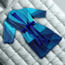 A template mockup of a blue robe on a bed. - PSD Mockup