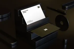 A black business card holder mockup on a table. - PSD Mockup