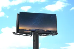 A billboard mockup with a blue sky and clouds. - PSD Mockup