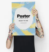 A man holding up a poster mockup. - PSD Mockup