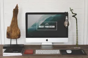 A mockup template of a desk with a computer and a desk lamp. - PSD Mockup