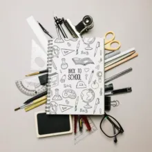 A back to school notebook surrounded by school supplies mockup. - PSD Mockup