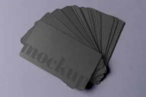 Black business card template on a purple surface. - PSD Mockup