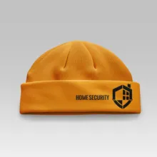 A mockup of an orange beanie with the words home security on it. - PSD Mockup