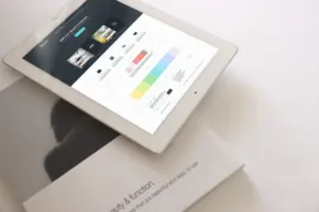 An ipad laying on top of a book, perfect for creating a mockup or template. - PSD Mockup