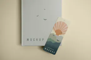 A book with a bookmark mockup next to it. - PSD Mockup