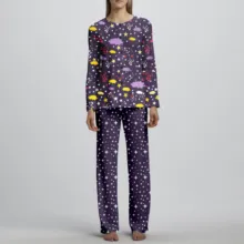 A woman wearing a purple pajama set with stars and planets poses for a mockup or template. - PSD Mockup