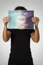 A woman holding up a mockup that says welcome party. - PSD Mockup