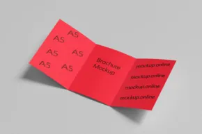 A red tri-fold brochure mockup on a grey background. - PSD Mockup