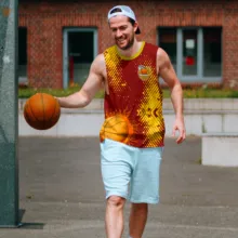 A man holding a basketball in a tank top mockup. - PSD Mockup