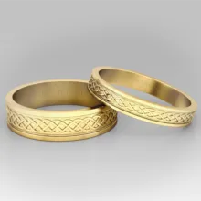 Two gold wedding rings with a celtic design, suitable for use as a mockup. - PSD Mockup