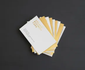 A stack of business cards on a black surface, perfect for a mockup. - PSD Mockup