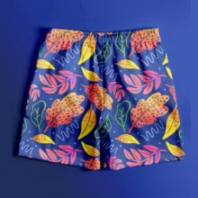 A mockup of shorts with colorful leaves on a blue background. - PSD Mockup